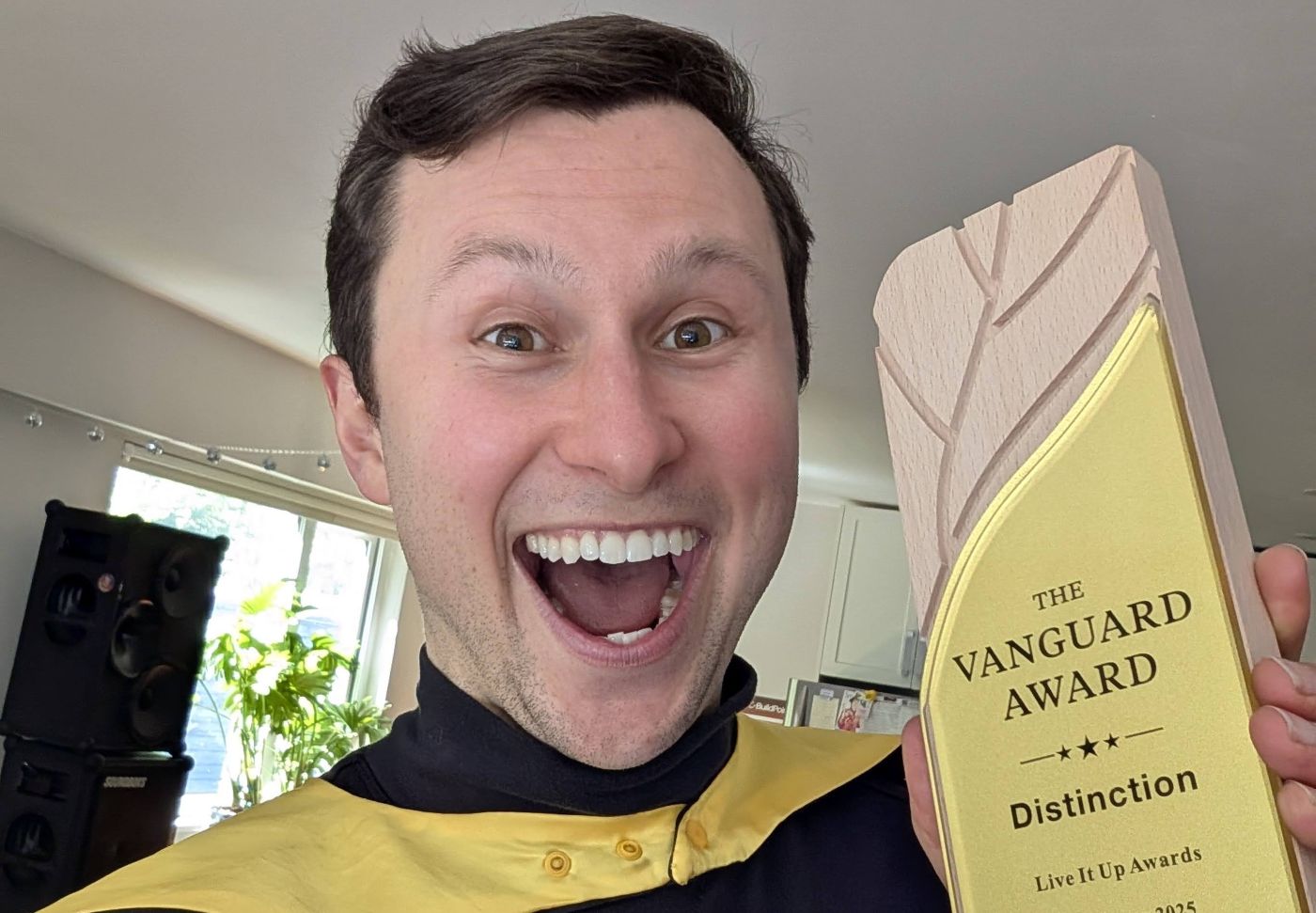 Jacques W. Martiquet holding The Vanguard Award trophy